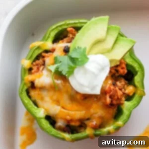 A perfectly cooked Mexican stuffed pepper with melted cheese on top.