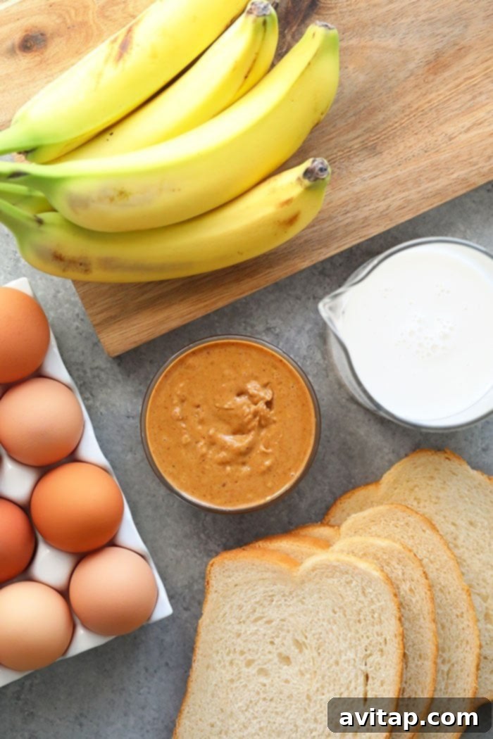 Collection of ingredients for Peanut Butter Banana French Toast Bake including eggs, bread, peanut butter, and bananas.