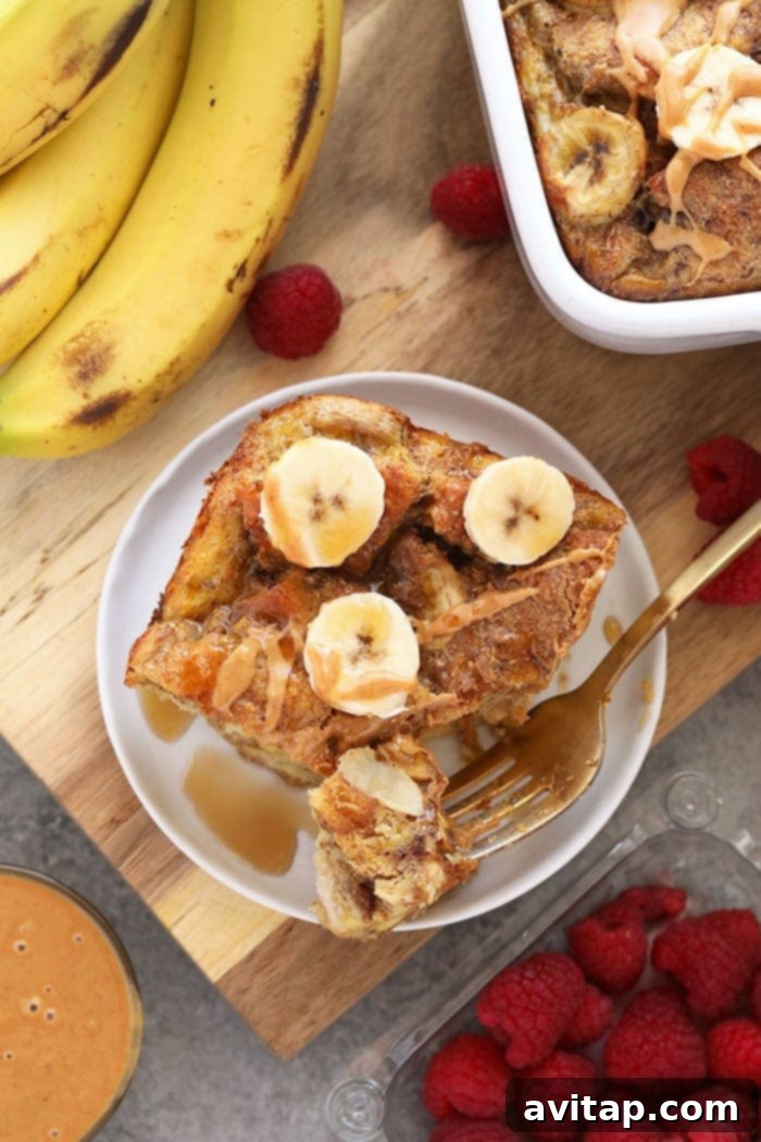 Serving spoons ready to scoop into a freshly baked Peanut Butter Banana French Toast Casserole.