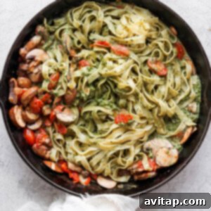 a skillet filled with pasta and vegetables.