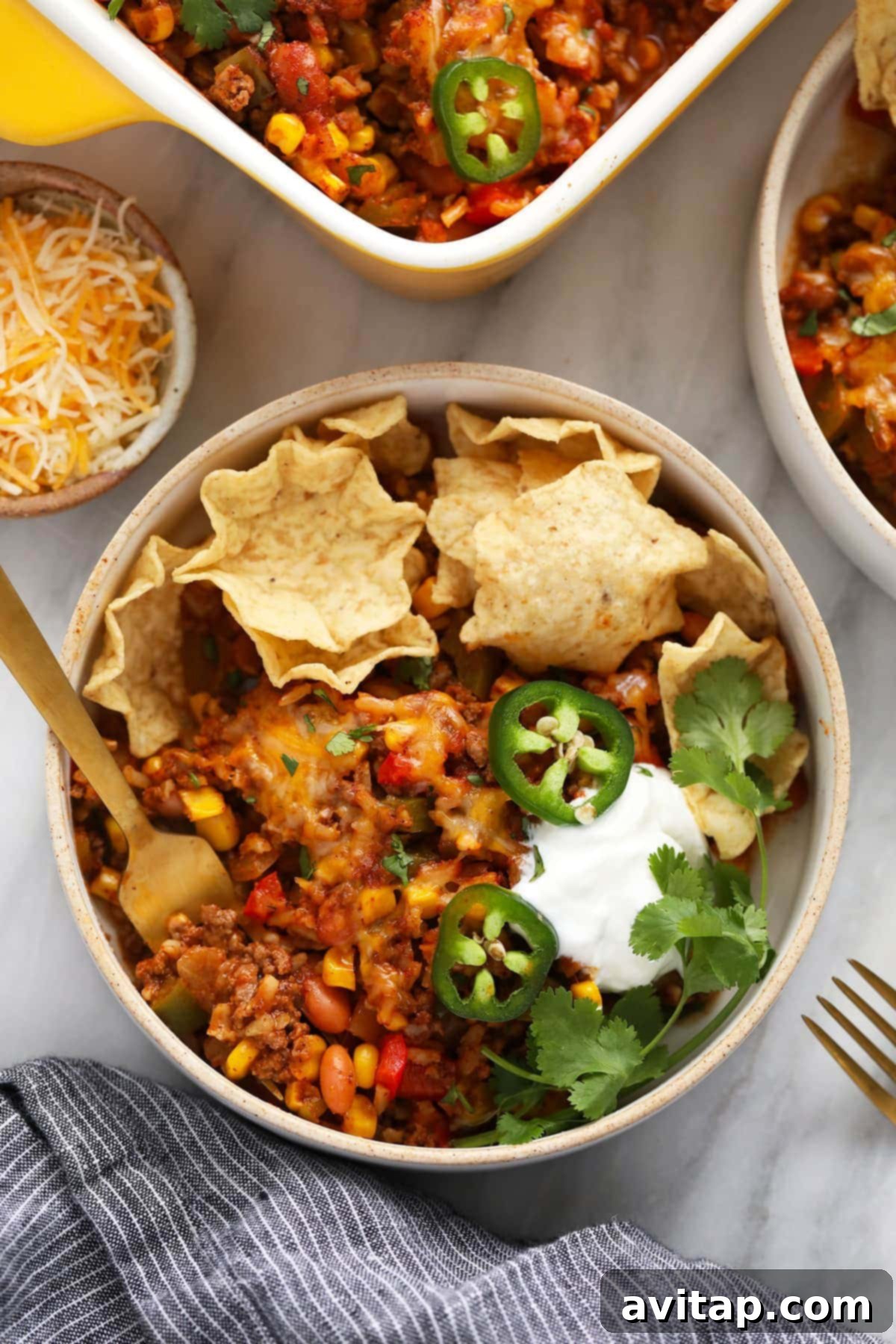 Mexican casserole in a bowl with tortilla chips.