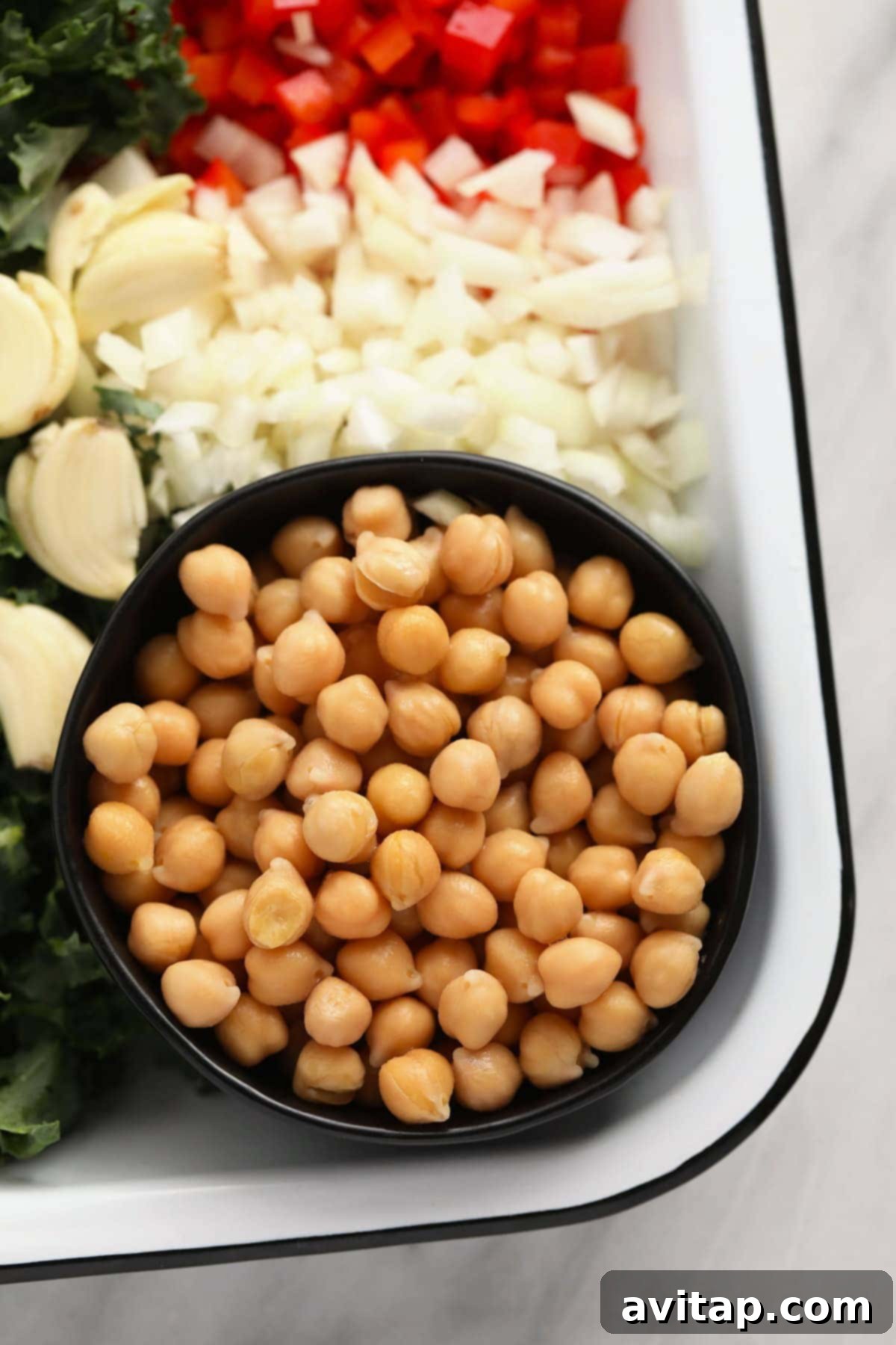 Ready-to-Use Chickpeas for Curry A close-up of perfectly rinsed chickpeas in a pristine white bowl, awaiting their addition to the simmering chickpea curry pot.