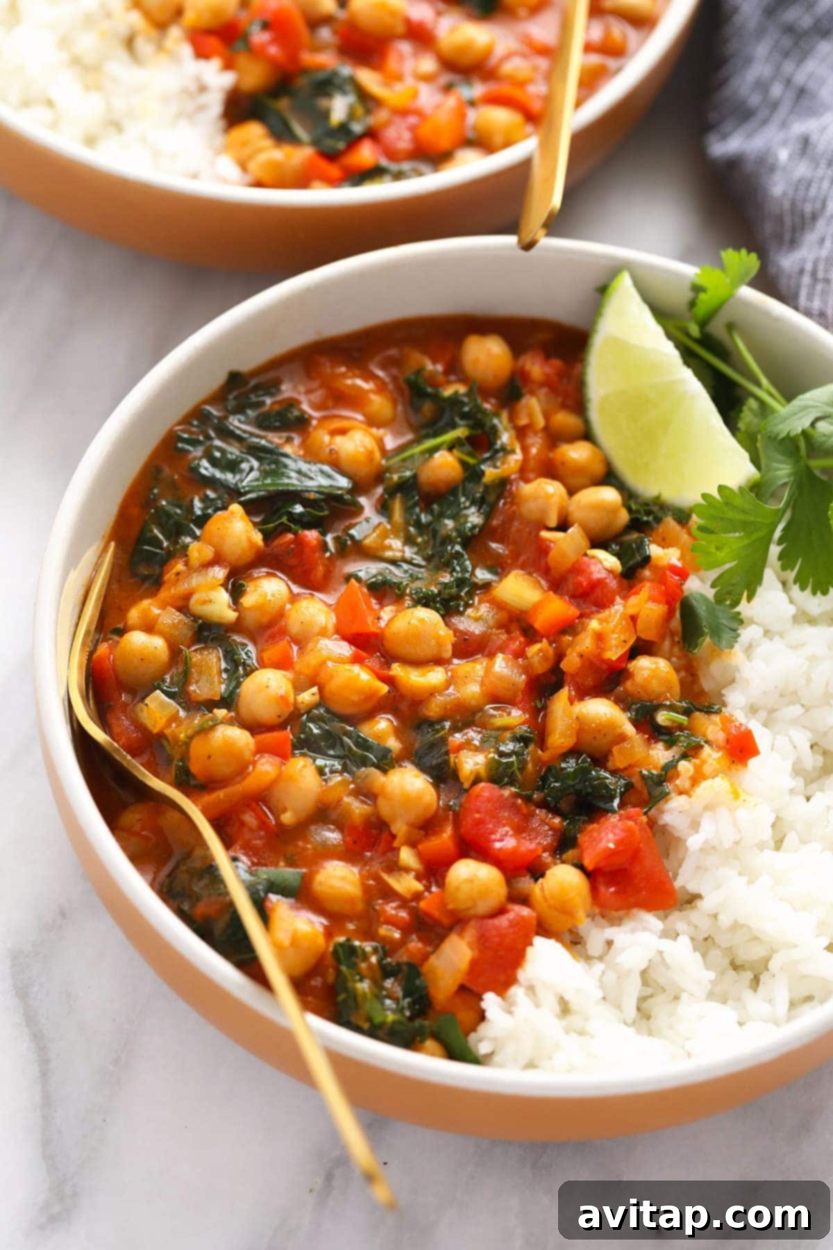 Freshly Made Chickpea Curry, Ready to Serve A beautifully presented bowl of freshly made chickpea curry, garnished with vibrant green herbs, ready to be enjoyed or carefully stored for later.