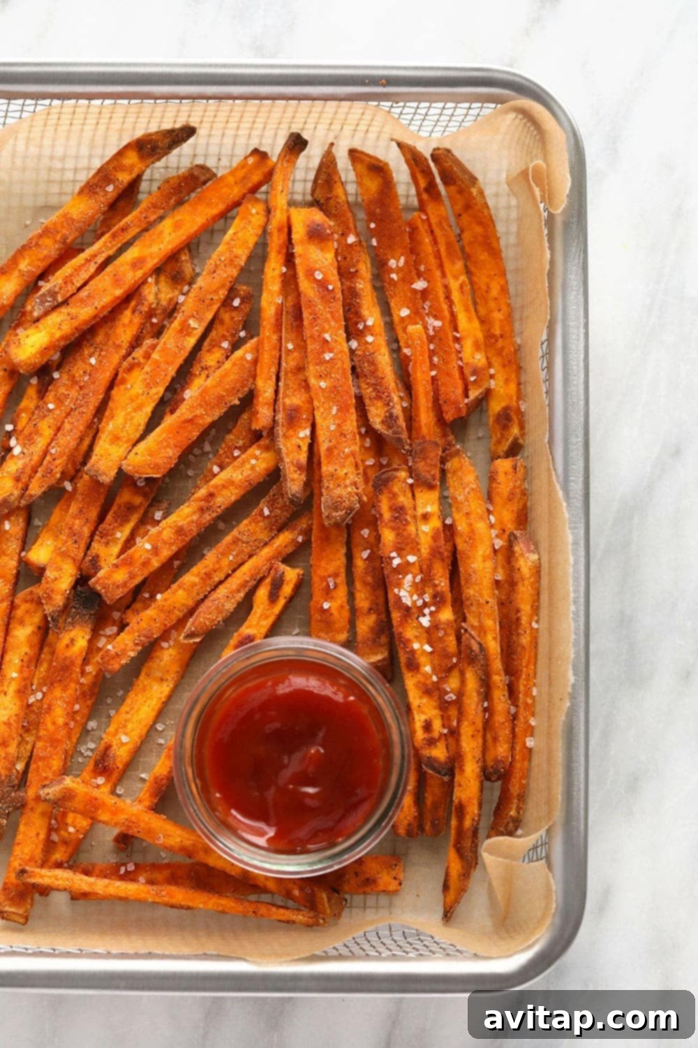 Crispy baked sweet potato fries in a rustic basket, ready to be served.