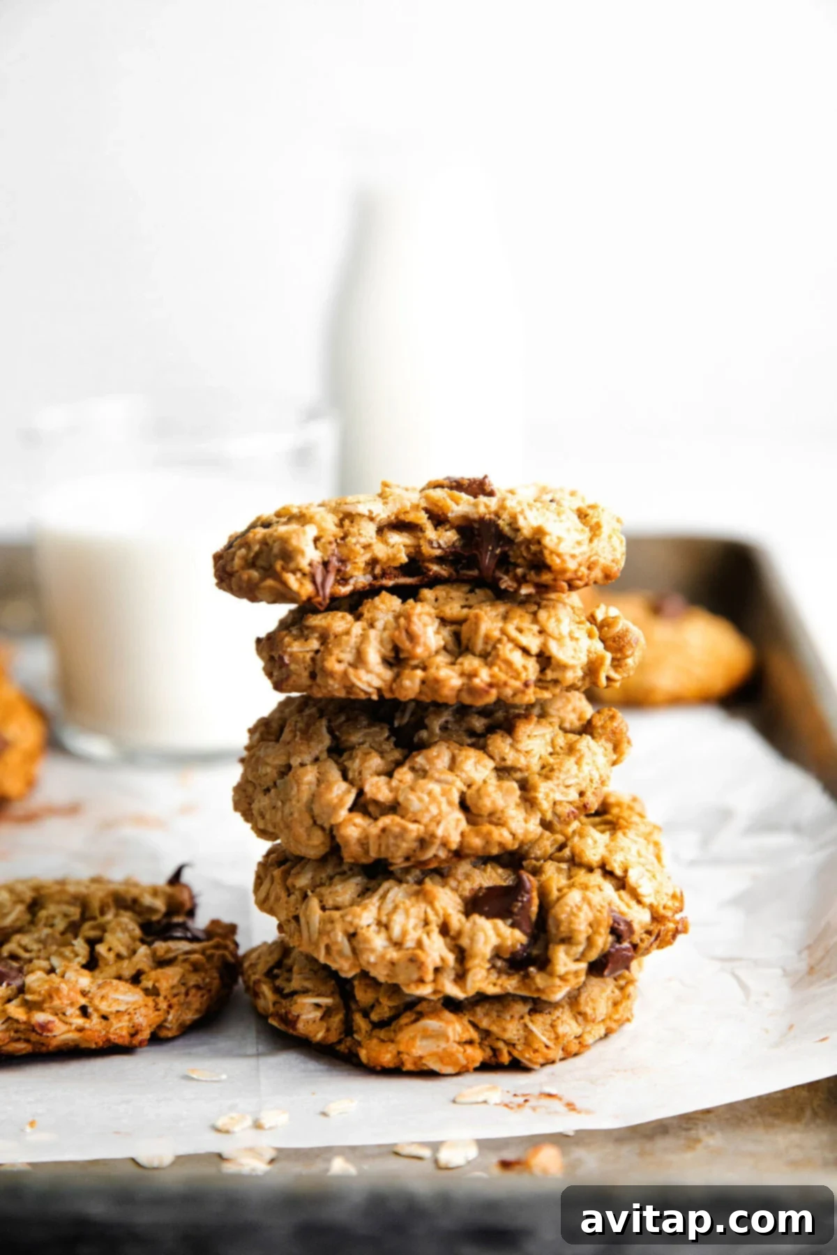 A stack of perfectly baked peanut butter oatmeal cookies, showcasing their golden-brown edges and soft centers, ready to be enjoyed.