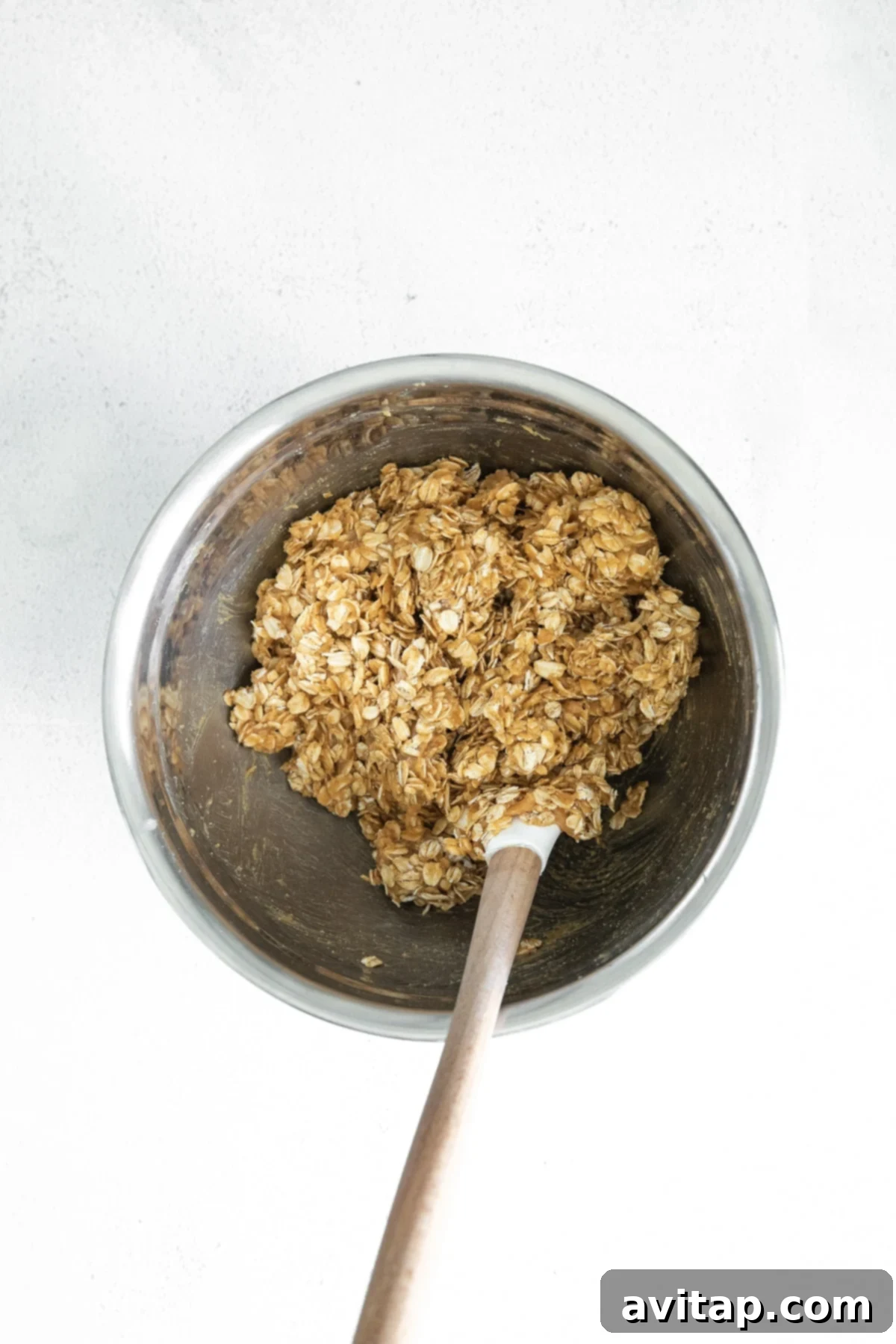 Peanut butter oatmeal cookie batter in a large mixing bowl, illustrating its thick and ready-to-bake consistency.