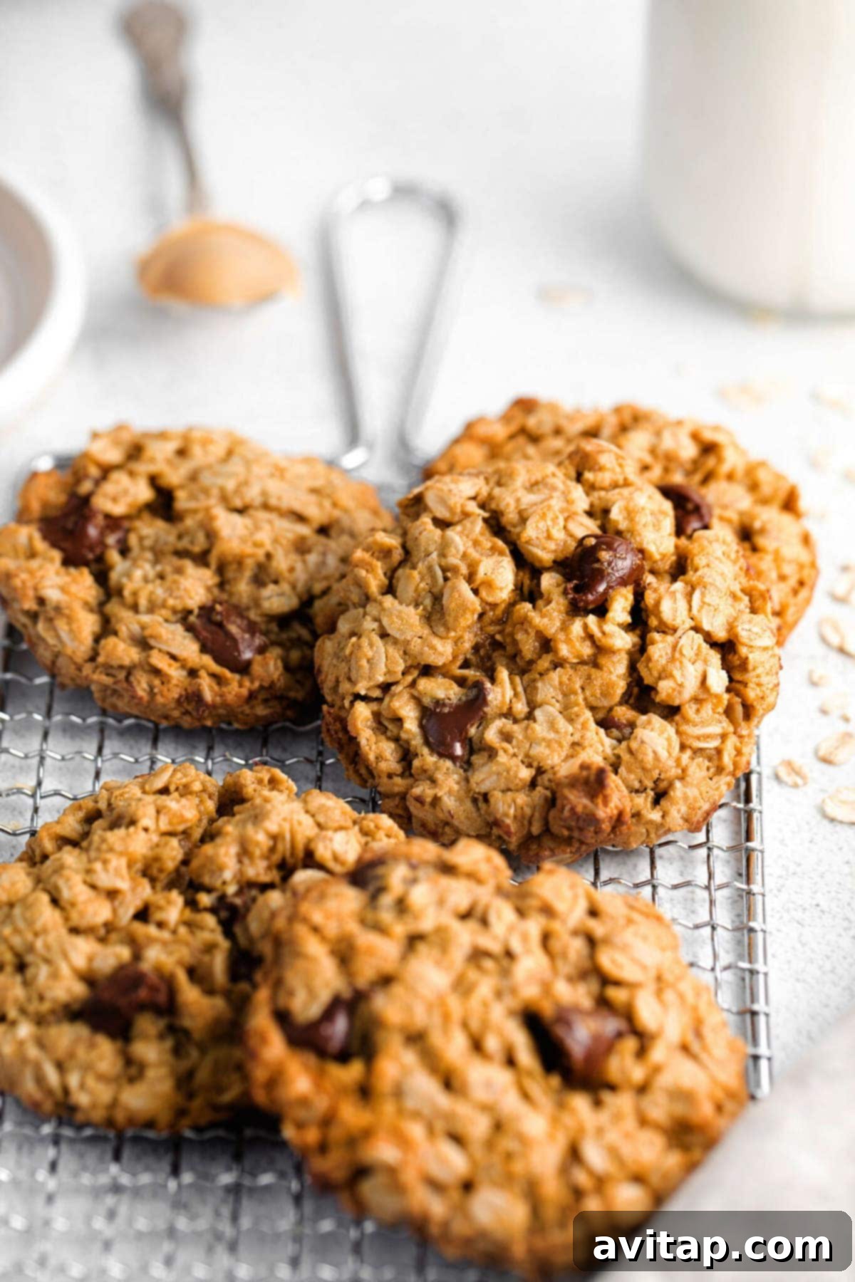 Freshly baked peanut butter oatmeal cookies cooling on a wire rack, allowing air circulation for even cooling.