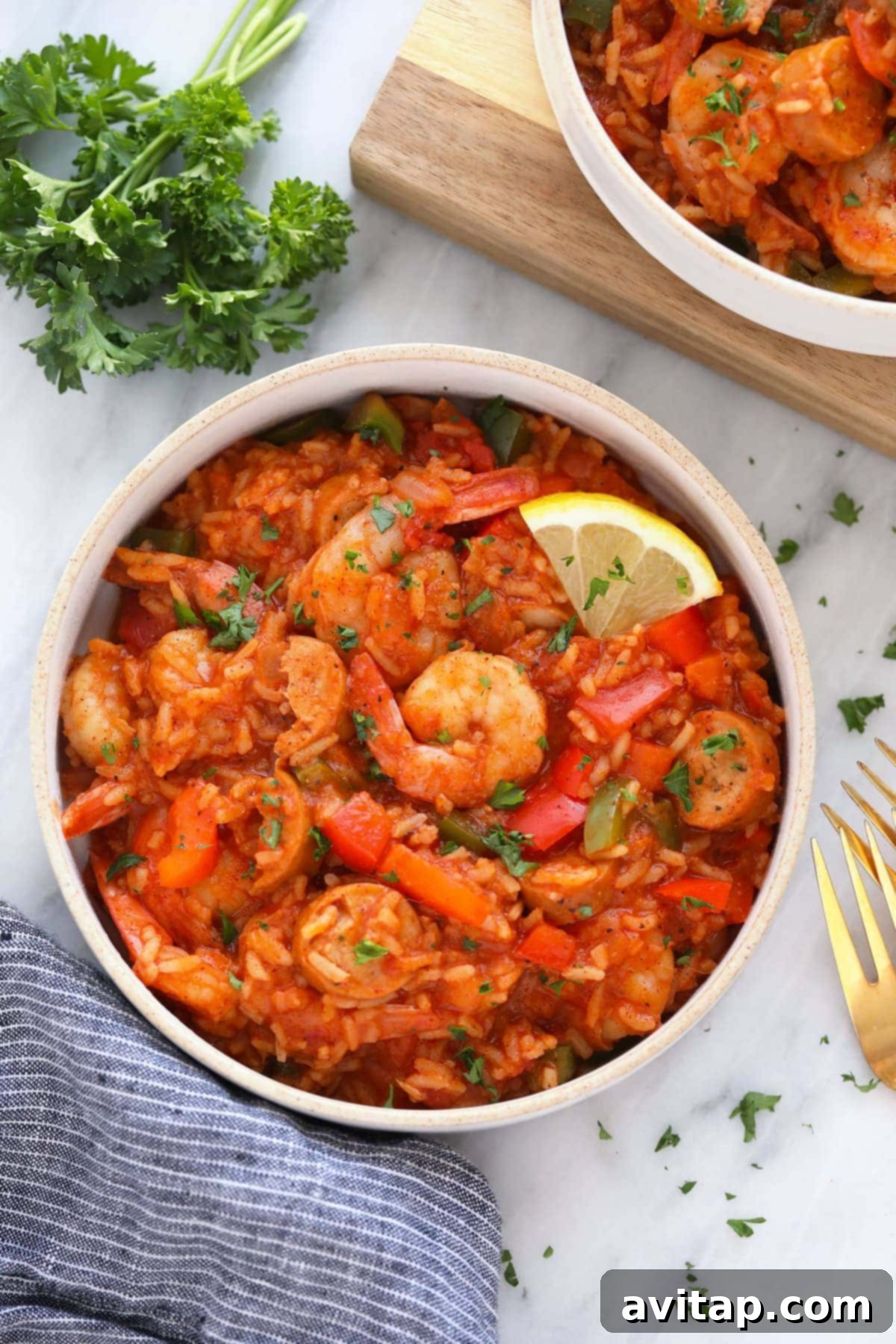 A vibrant bowl of Instant Pot Jambalaya, garnished with a fresh lemon slice and herbs, ready to be enjoyed.