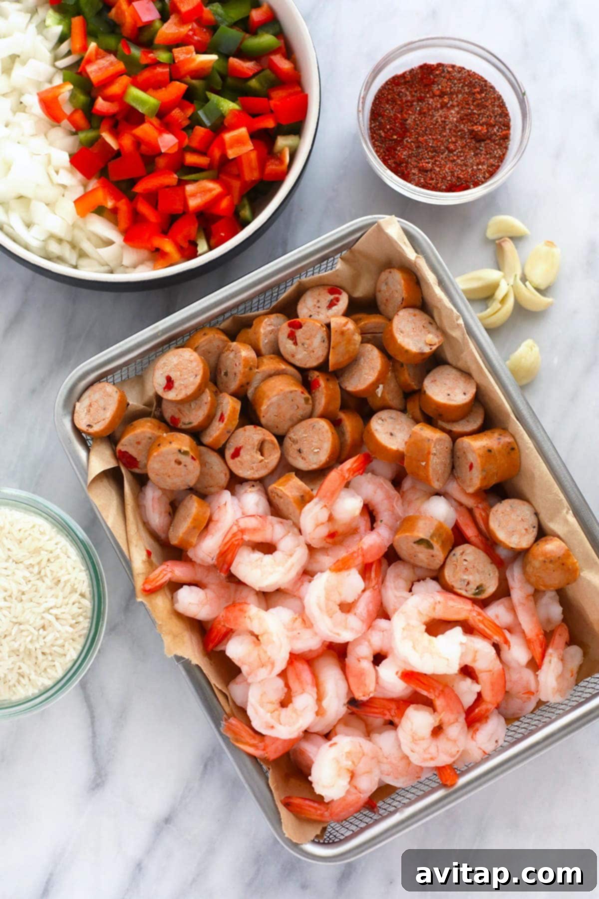An array of fresh, vibrant ingredients for Instant Pot Jambalaya, neatly arranged in bowls on a kitchen counter.