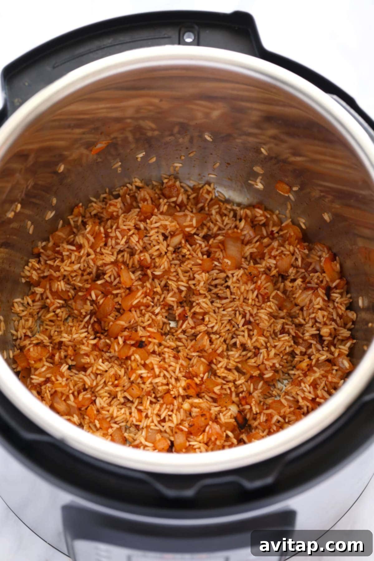 Close-up view of the raw ingredients for jambalaya, including vegetables, rice, and broth, nestled in an Instant Pot before cooking.