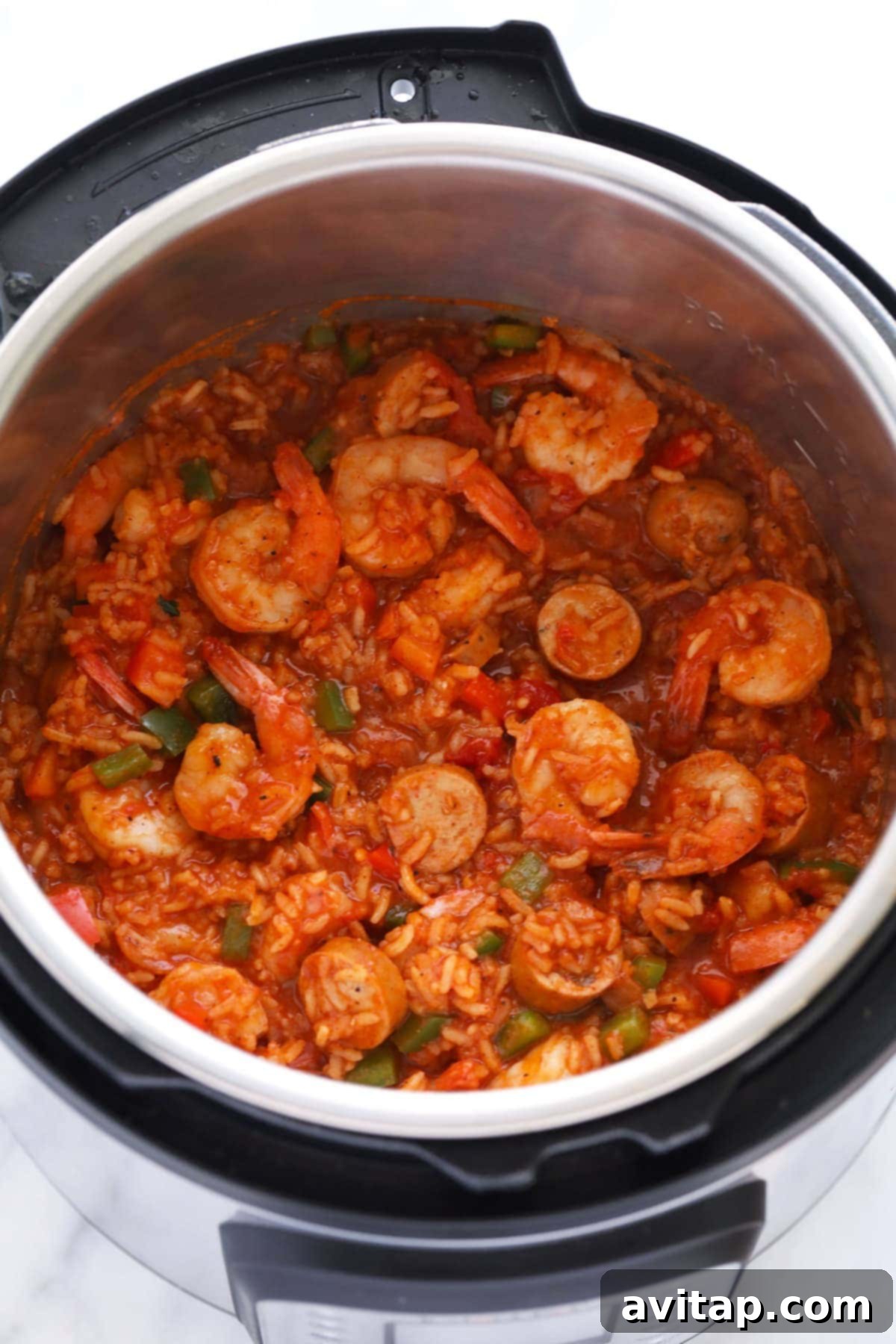 A close-up view of finished Instant Pot Jambalaya, rich with shrimp and andouille sausage, ready to be served from the pot.