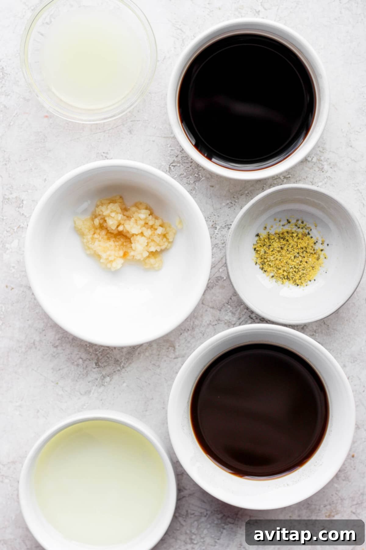 Various marinade ingredients neatly arranged in small bowls, ready to be combined.