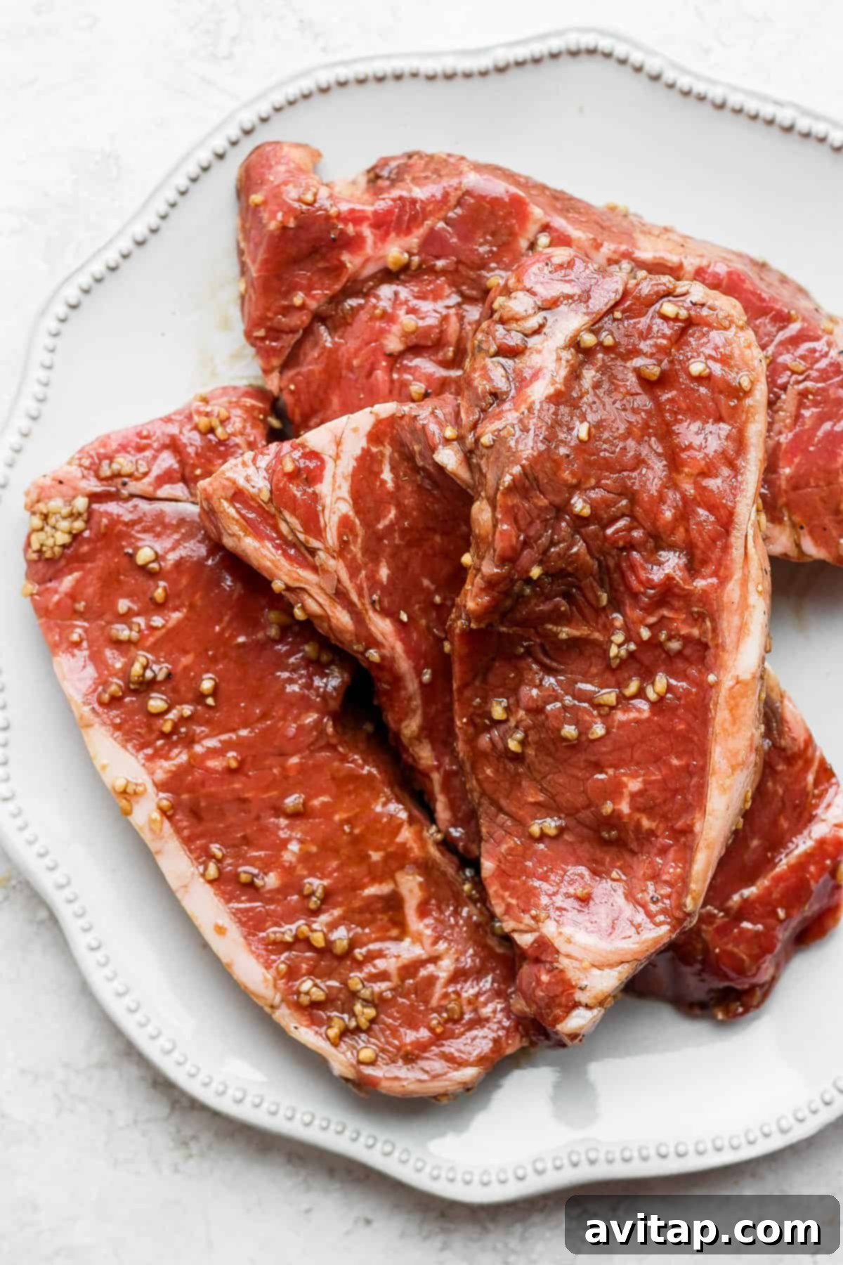 Delicious marinated steaks, perfectly cooked and arranged on a plate.