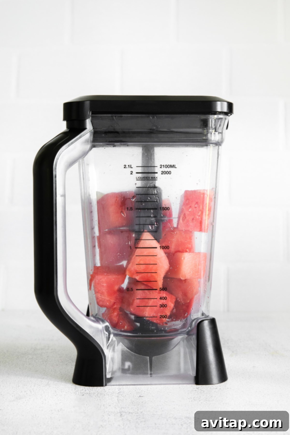 Freshly cut watermelon cubes ready to be blended in a high-speed blender, preparing for the margarita recipe.