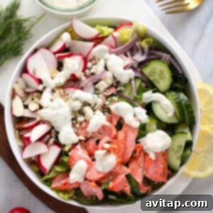 A large bowl of salmon salad with Greek yogurt dressing, garnished with fresh dill and radishes, perfectly arranged and ready to be served.