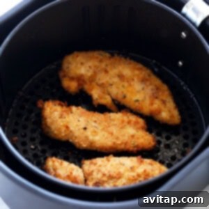 Dipping a crispy air fryer chicken tender in ranch