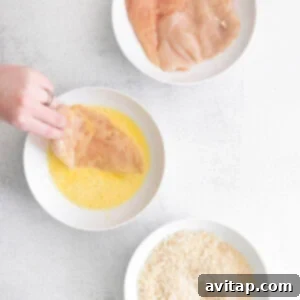dipping chicken into egg.