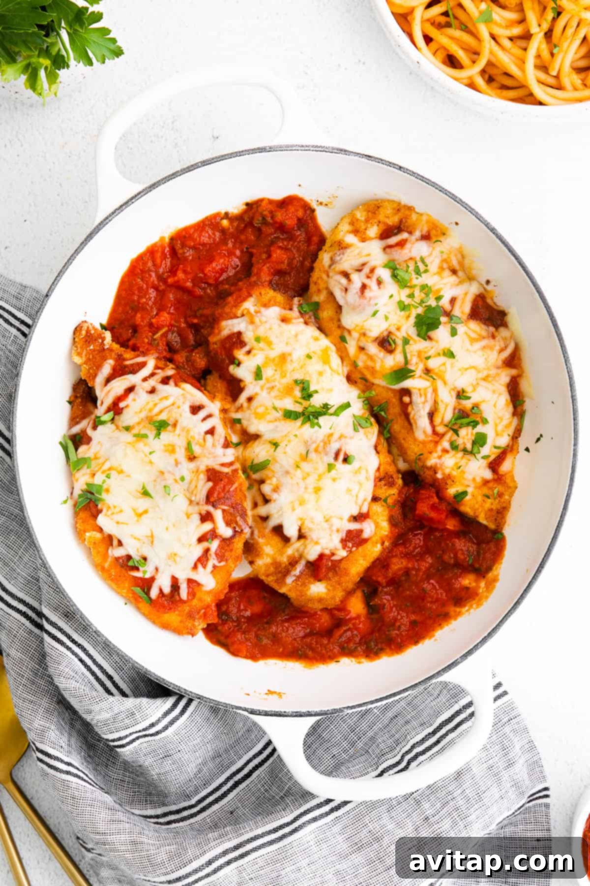 Bubbly chicken parmesan in a baking dish, fresh from the oven.