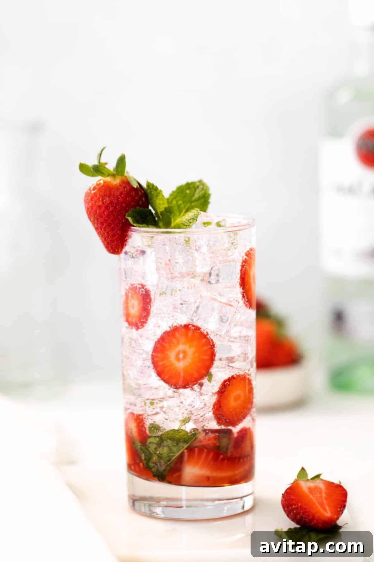 Beautifully garnished strawberry mojito cocktail in a tall glass