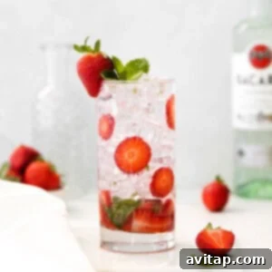 Strawberry Mojito served in a glass with mint and strawberry garnish