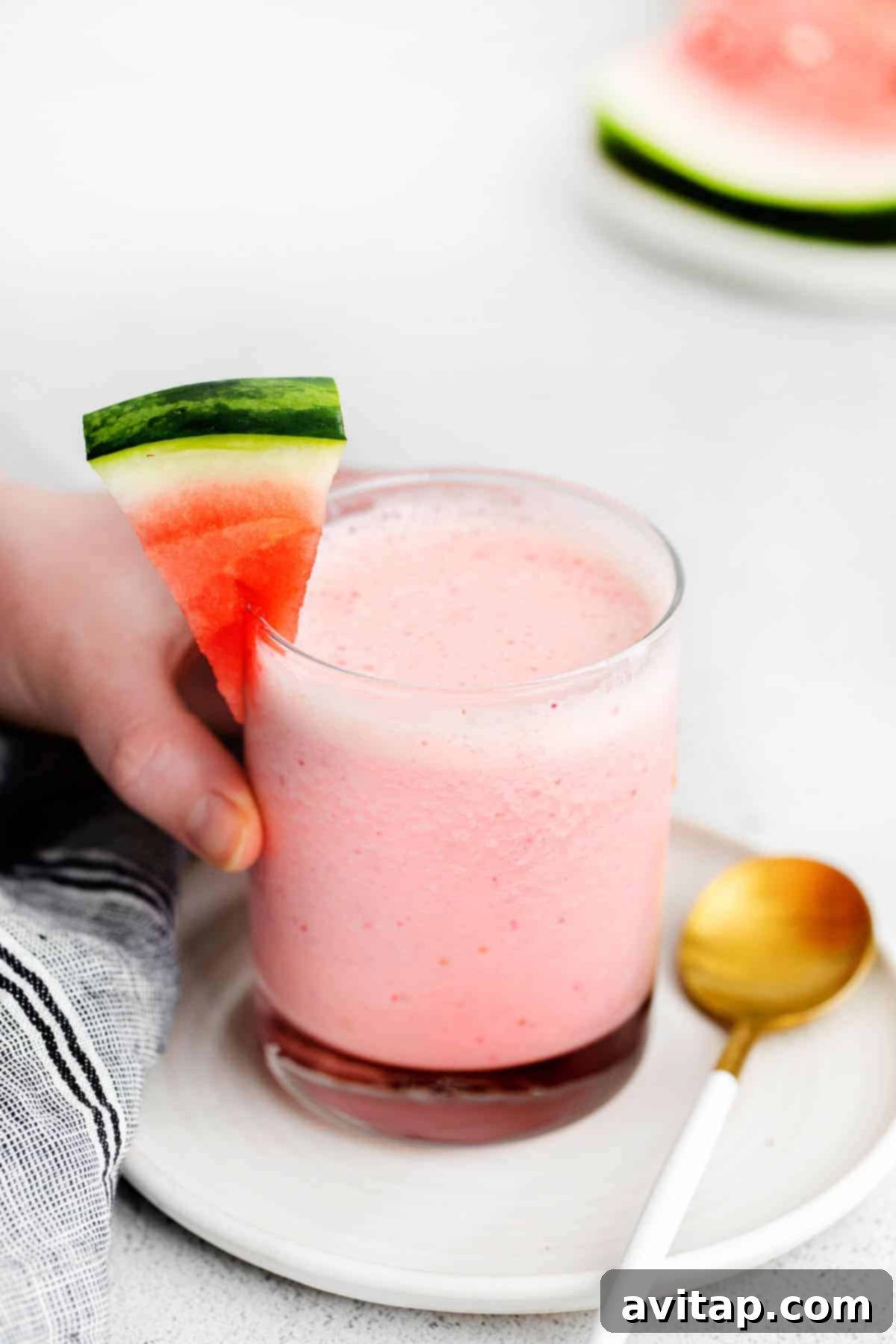 A beautifully presented watermelon smoothie in a glass, ready to be enjoyed.