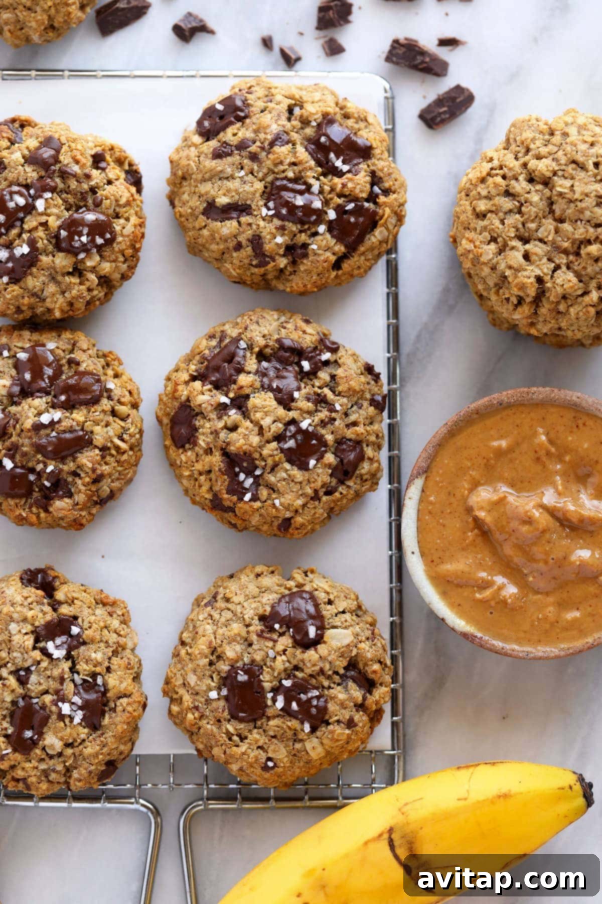 Delicious Peanut Butter Banana Cookies with dark chocolate chunks cooling on a wire rack.