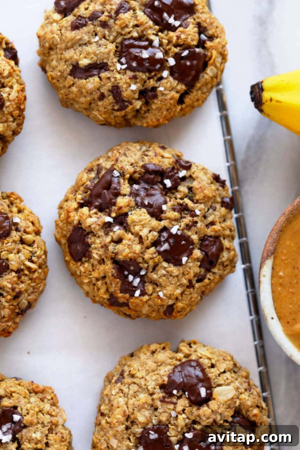 Close-up shot of individual Peanut Butter Banana Oatmeal Cookies with generous dark chocolate chunks, showcasing their soft, chewy texture.