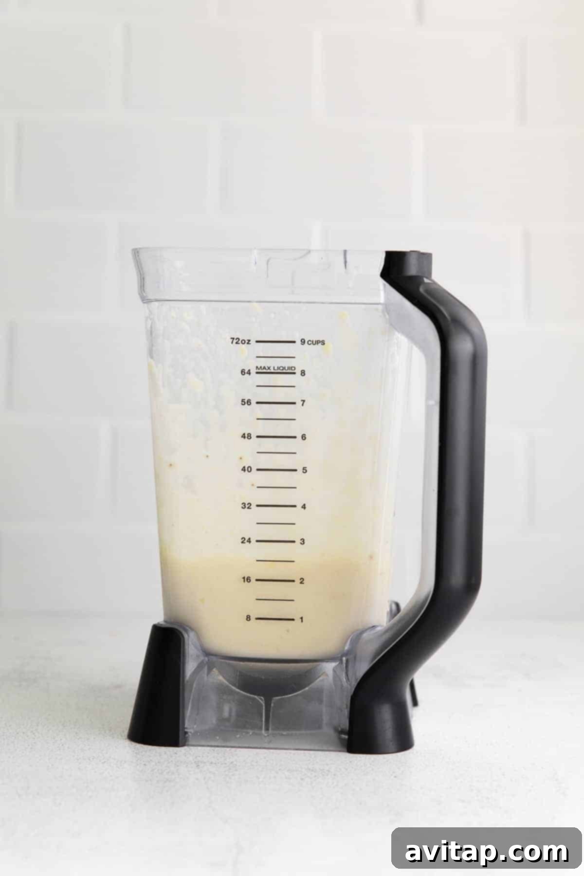 A perfectly blended pineapple smoothie inside a high-speed blender, showcasing its smooth, creamy texture.