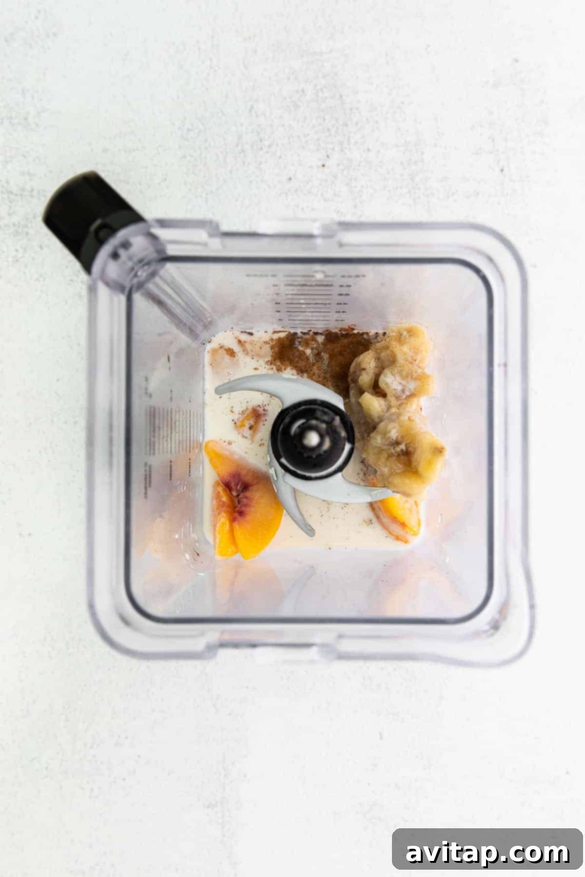 Get peachy with this simple peach smoothie recipe! This smoothie tastes just like a peach pie because it has hints of ground cinnamon and is so delicious. All the peach smoothie ingredients placed inside a high-speed blender, ready for blending