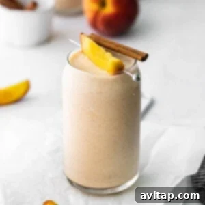 Creamy peach smoothie in a glass, ready to be enjoyed