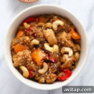 A vibrant Cashew Chicken Quinoa Casserole with visible chicken, bell peppers, and cashews, ready to be served.