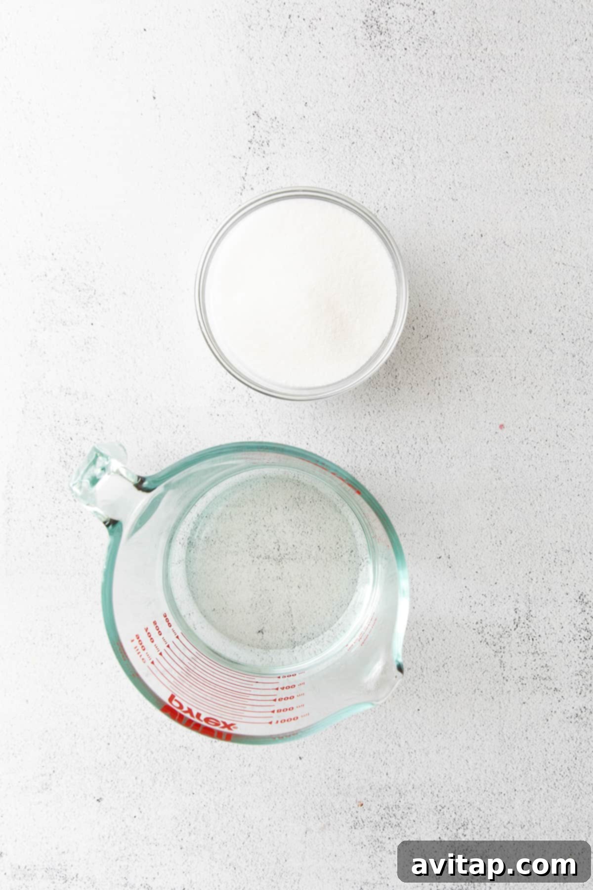 Bowls of water and granulated sugar, the two fundamental ingredients for making simple syrup.