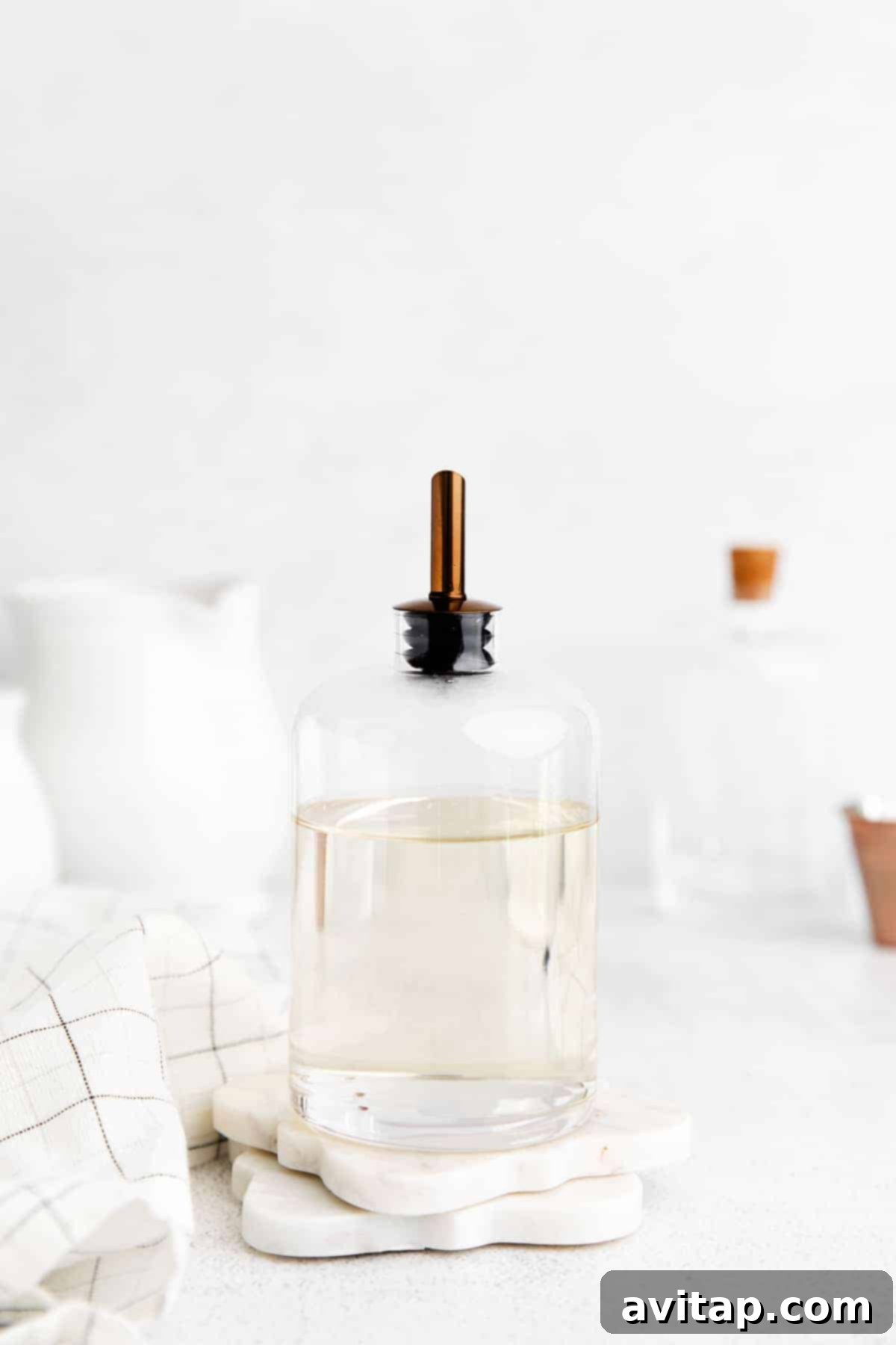 A bottle of homemade simple syrup with a label, ready for storage or use in cocktails.