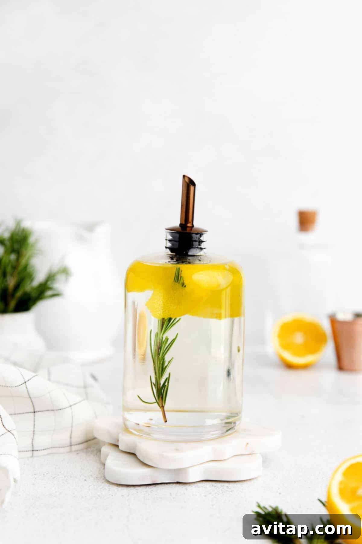 Bottles of homemade simple syrup, one infused with rosemary and lemon slices, ready for use.