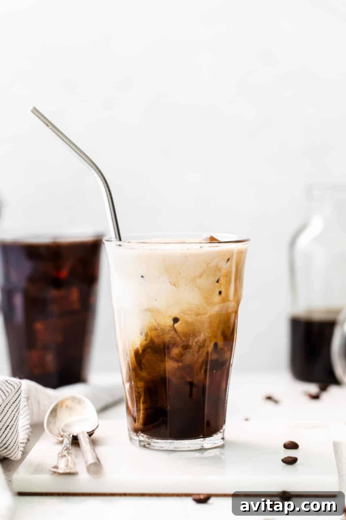 A large glass of cold brew coffee with ice, emphasizing its refreshing quality.