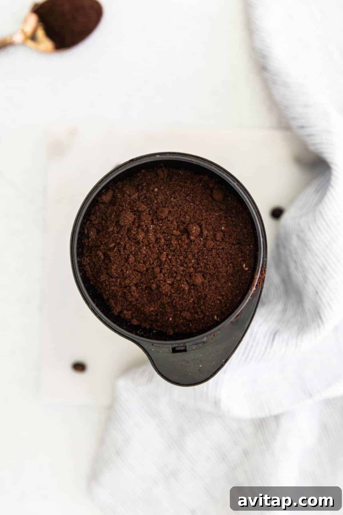Coffee grounds in a coffee grinder, ready for brewing.