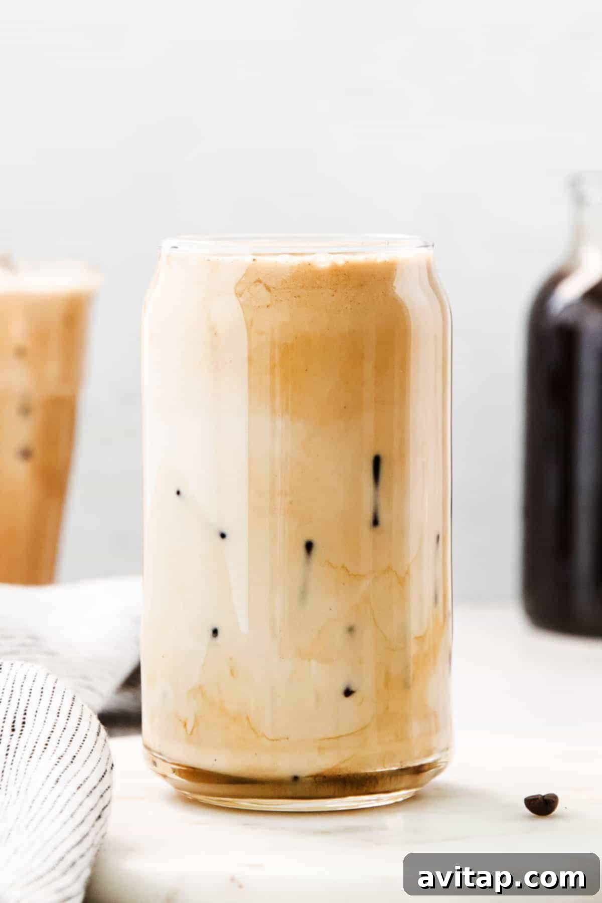 Velvet Vanilla Cold Brew 11 A tall glass filled with delicious vanilla sweet cream cold brew, condensation on the glass, ready to be enjoyed on a warm day.