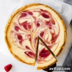 A beautifully presented healthy cheesecake, showcasing its creamy texture and vibrant raspberry swirl.