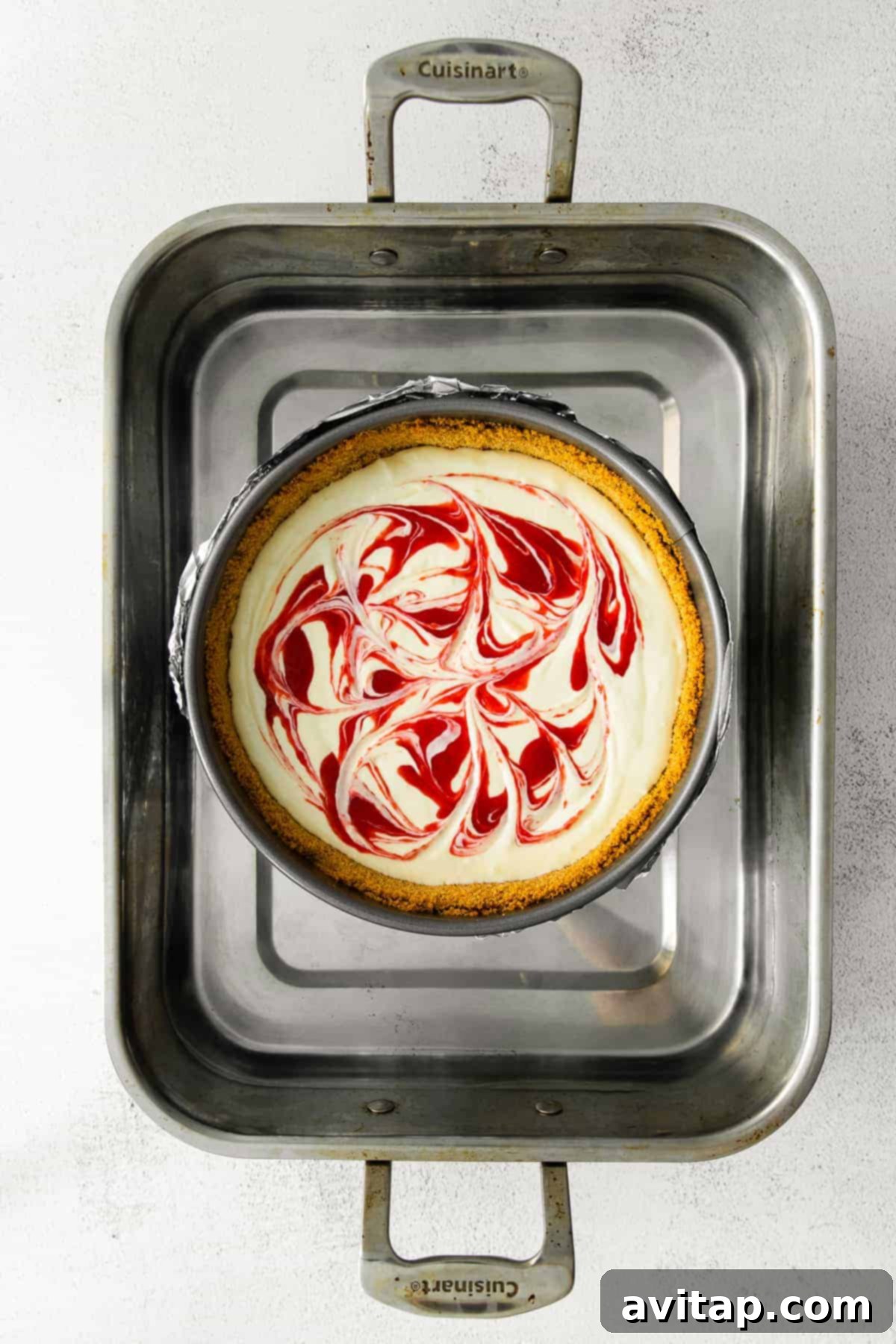 A Greek yogurt cheesecake meticulously baking in a water bath inside a warm oven, ensuring a gentle, even bake.