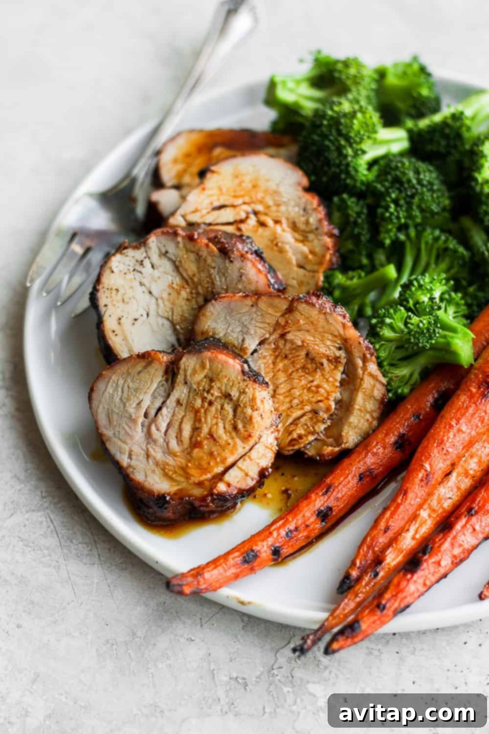 Perfectly Cooked Marinated Pork Tenderloin Close-up of juicy, perfectly sliced pork tenderloin on a plate, ready to serve.