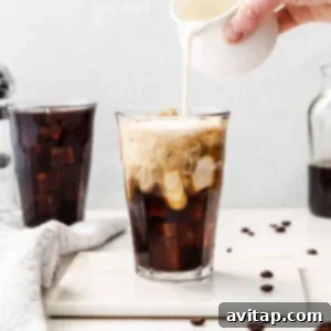 A glass of cold brew coffee with cream, perfect for a refreshing pick-me-up.