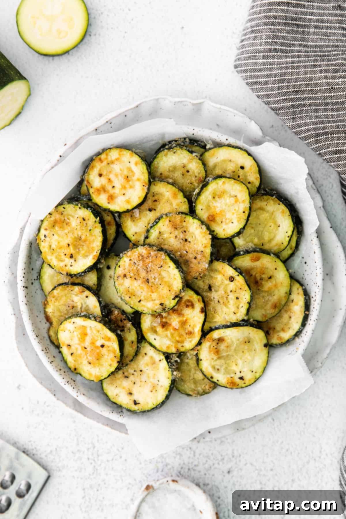 Golden Parmesan Zucchini 2 Crispy Parmesan Baked Zucchini in a white bowl, ready to be served.