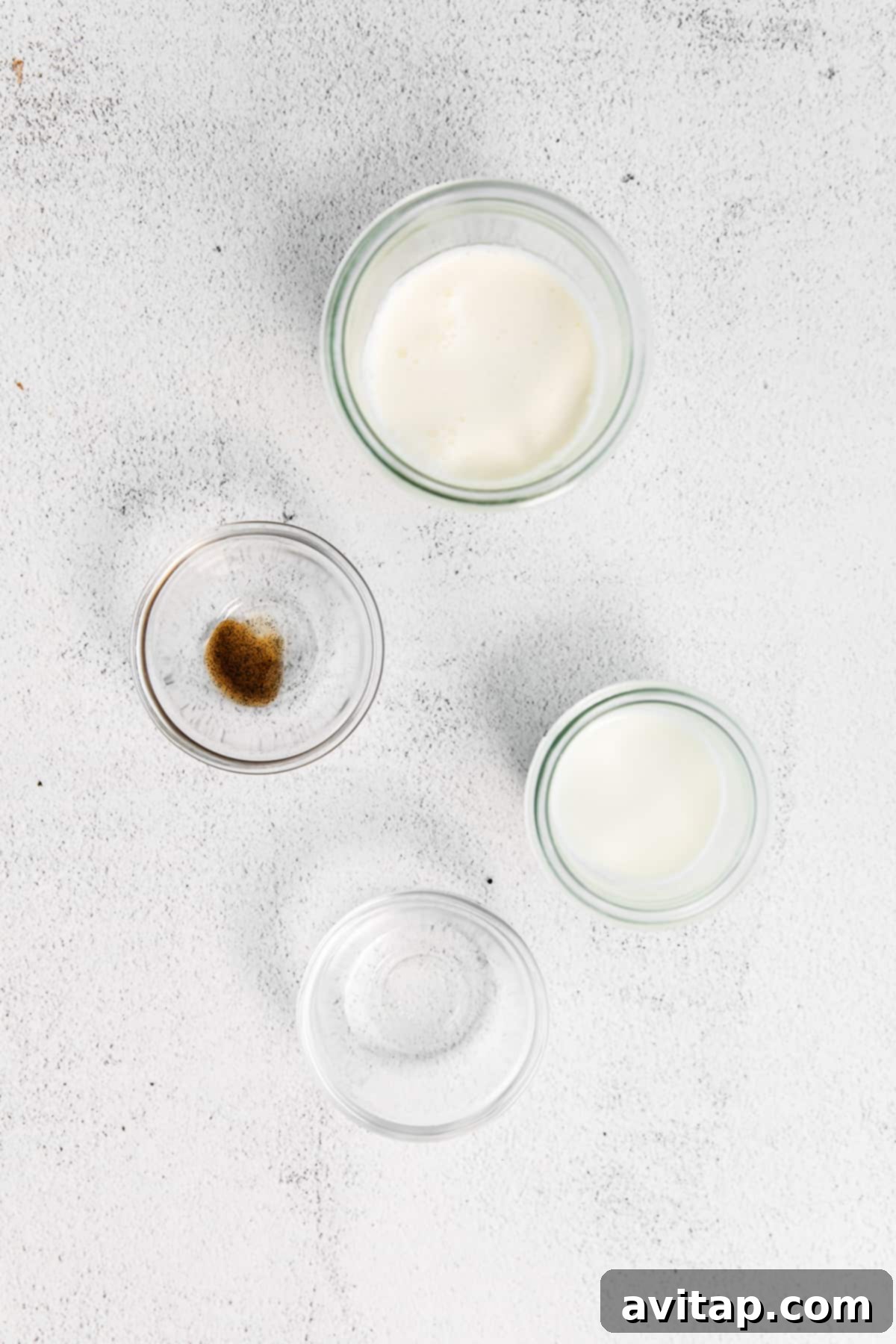 Ingredients for vanilla sweet cream cold foam laid out on a kitchen countertop.