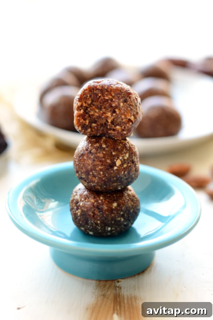 Delicious Cherry Pie Energy Balls on a plate, showcasing their rich color and texture.