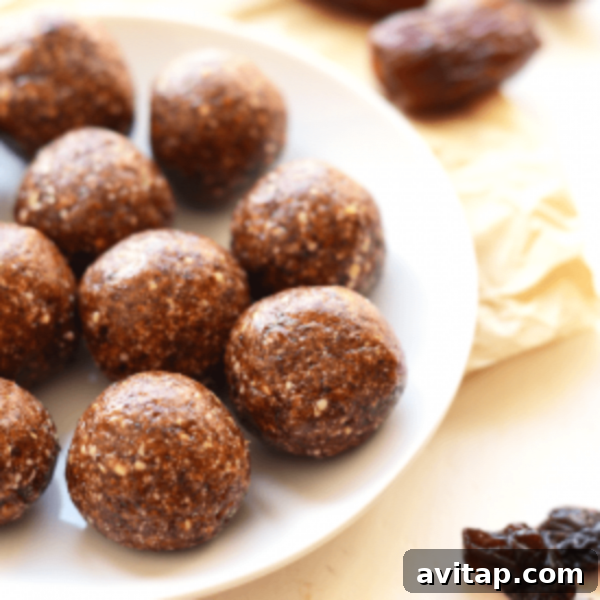 Delicious chocolate energy balls arranged on a white plate, ready to be enjoyed as a quick snack.