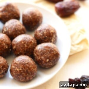 Freshly rolled cherry pie energy balls arranged on a plate.