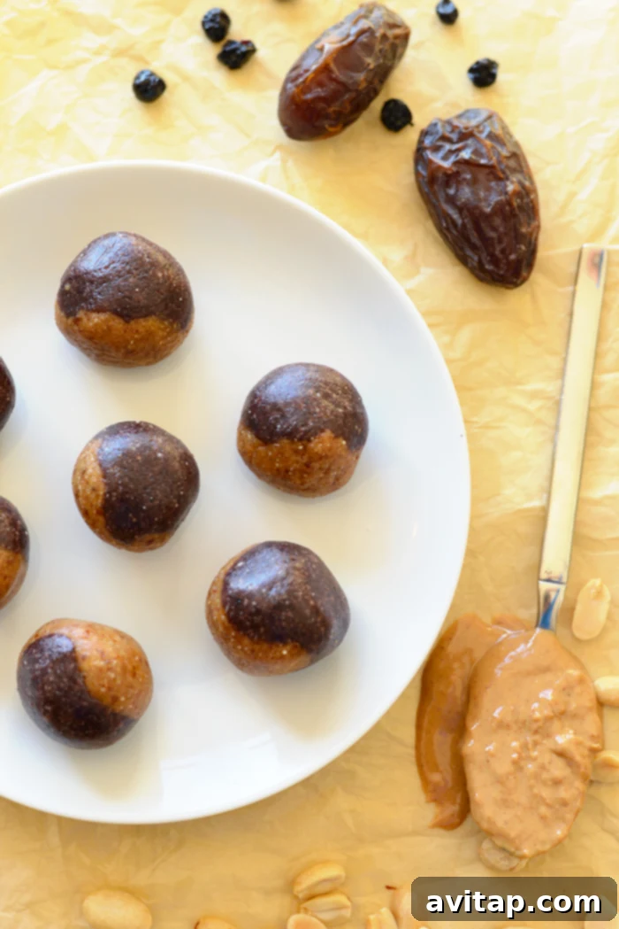 Assortment of no-bake peanut butter and jelly energy balls in a bowl, showcasing the healthy ingredients.