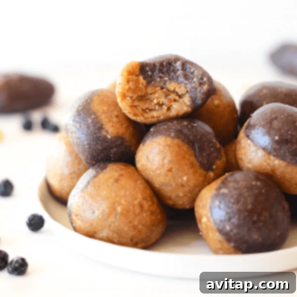 Delicious chocolate peanut butter energy balls on a white plate, ready to be enjoyed.