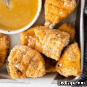A plate of golden brown crispy chicken nuggets, ready to be enjoyed.