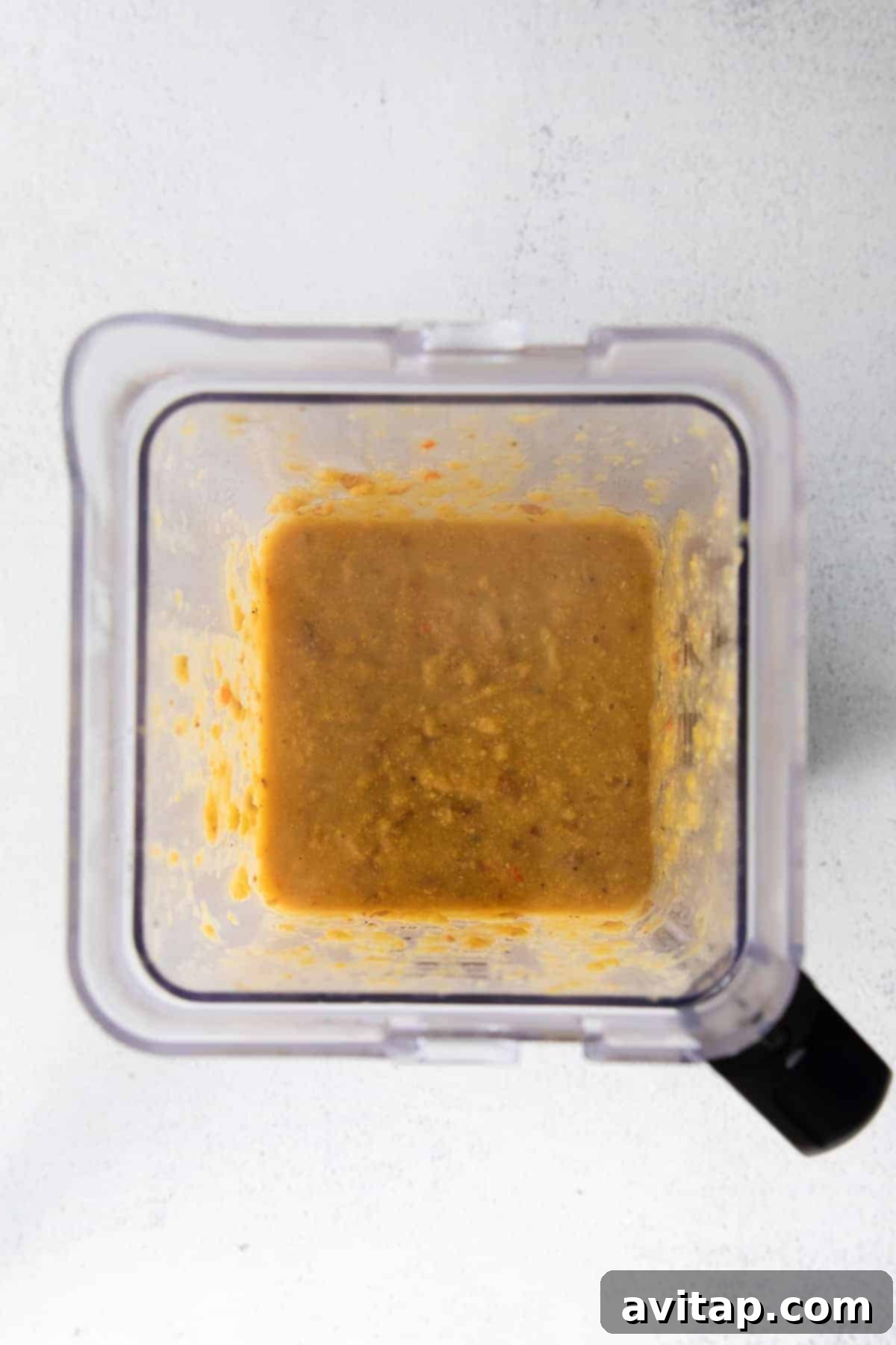 A portion of the corn chowder being blended in a high-speed blender to create a creamy texture.